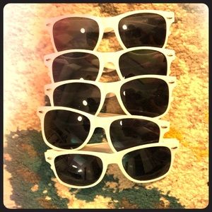 5 pair of white sunglasses